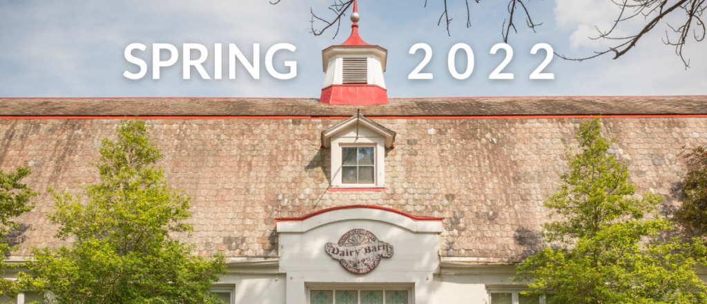 A photo of the roof line of The Dairy Barn on a beautiful Spring day. Text reading SPRING 2022 frames one of the historic cupolas.
